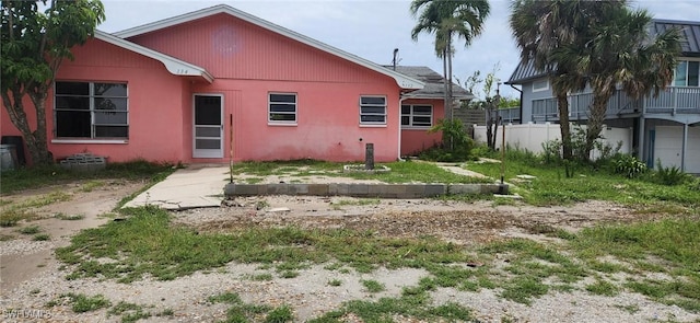 back of property featuring stucco siding