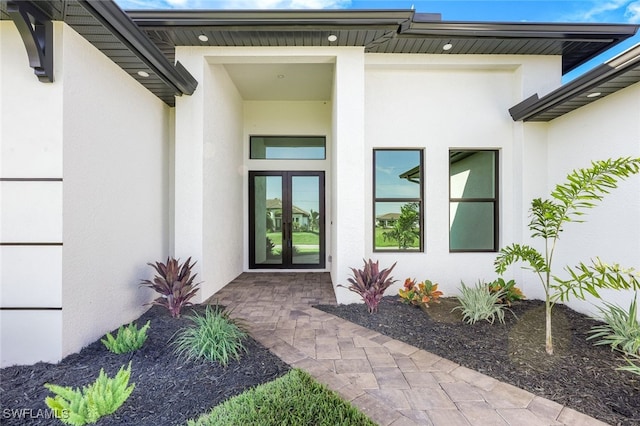 view of exterior entry featuring french doors