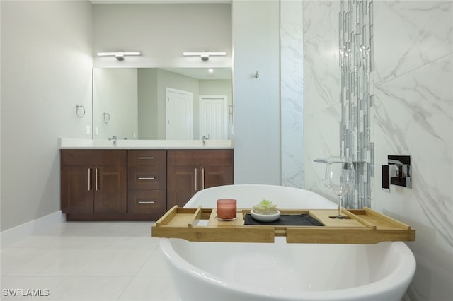 full bathroom featuring a sink, a freestanding tub, and double vanity