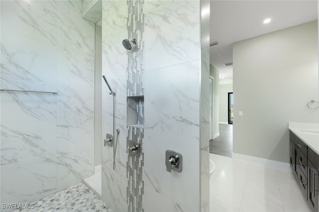 bathroom featuring a marble finish shower, visible vents, vanity, and baseboards