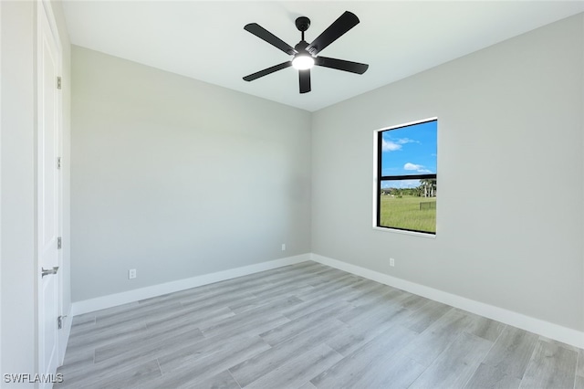 unfurnished room with light wood-style floors, baseboards, and ceiling fan