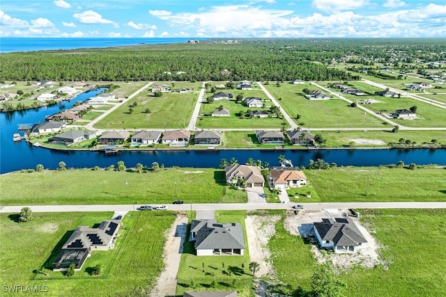 birds eye view of property with a residential view and a water view