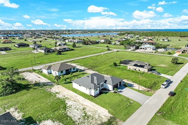 birds eye view of property featuring a residential view and a water view