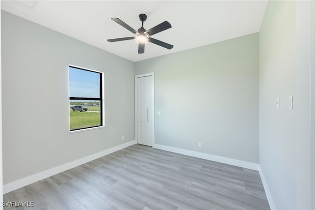 unfurnished room featuring ceiling fan, baseboards, and light wood-style flooring