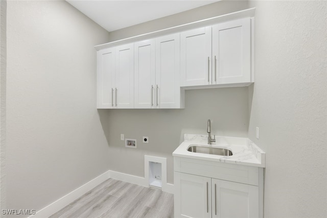 laundry room with baseboards, washer hookup, cabinet space, electric dryer hookup, and a sink