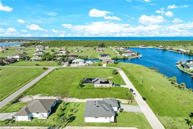 bird's eye view featuring a water view and a residential view