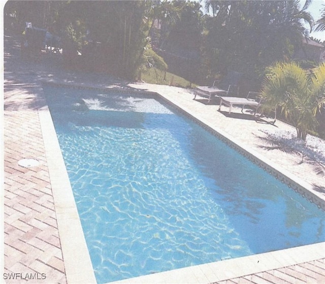 outdoor pool featuring a patio