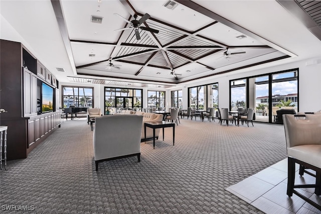 carpeted living room with coffered ceiling, ceiling fan, and a tray ceiling