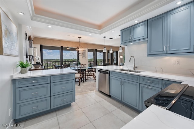 kitchen with sink, blue cabinetry, dishwasher, a tray ceiling, and decorative light fixtures