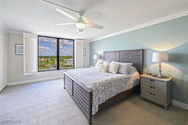 bedroom with crown molding, light colored carpet, and ceiling fan