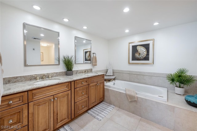 bathroom with vanity, tiled tub, and tile patterned floors