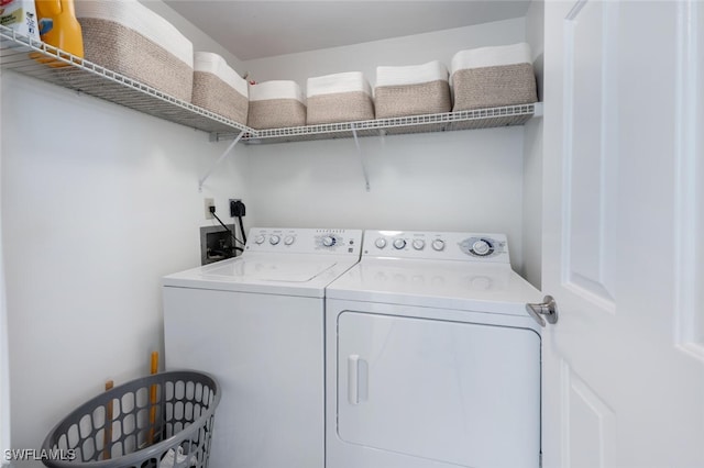 clothes washing area with separate washer and dryer