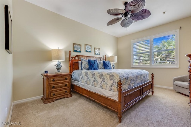 bedroom with baseboards, a ceiling fan, and light carpet