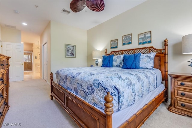 bedroom with visible vents, a ceiling fan, carpet flooring, and connected bathroom