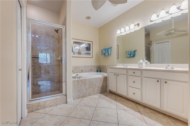 full bathroom featuring a bath, ceiling fan, a shower stall, double vanity, and tile patterned flooring
