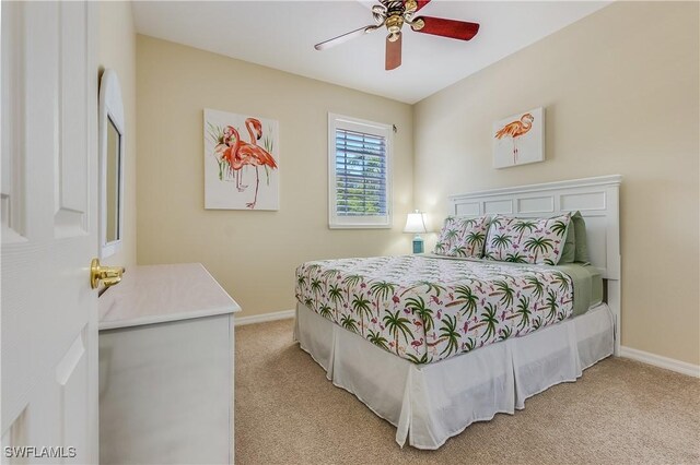 bedroom featuring baseboards, a ceiling fan, and light colored carpet