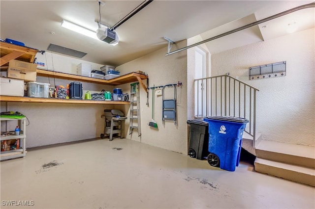 garage with a garage door opener and a textured wall