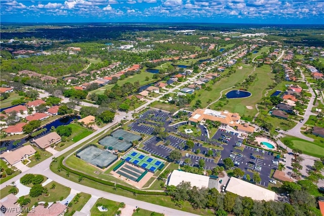 bird's eye view featuring golf course view, a residential view, and a water view