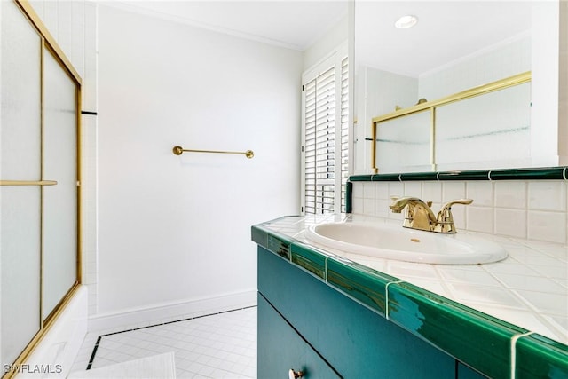 bathroom with decorative backsplash, vanity, tile patterned floors, and bath / shower combo with glass door