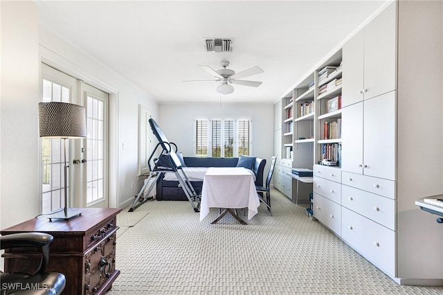 carpeted office space with french doors and ceiling fan