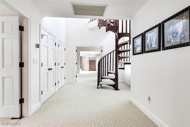 hallway featuring light colored carpet and crown molding