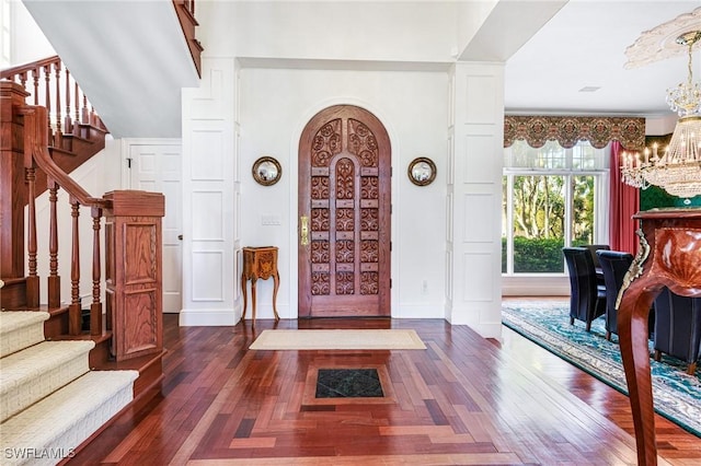 foyer featuring dark hardwood / wood-style flooring and a notable chandelier