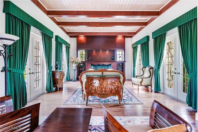 interior space featuring beamed ceiling, plenty of natural light, french doors, and light hardwood / wood-style flooring