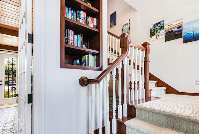 stairway with built in features and wood-type flooring