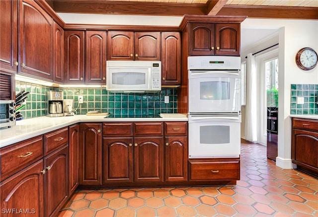 kitchen with decorative backsplash, light tile patterned floors, beamed ceiling, and white appliances