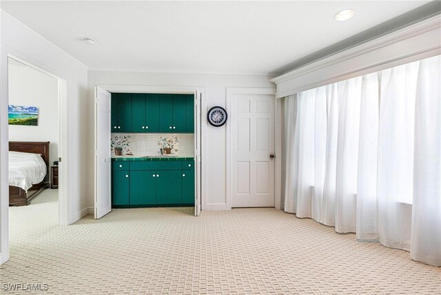 interior space with light carpet and tasteful backsplash