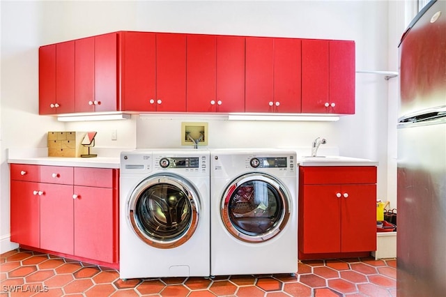 clothes washing area with washing machine and clothes dryer, sink, light tile patterned floors, and cabinets