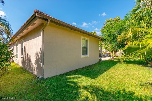 view of home's exterior featuring a yard