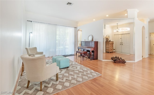 living area featuring light hardwood / wood-style flooring and crown molding