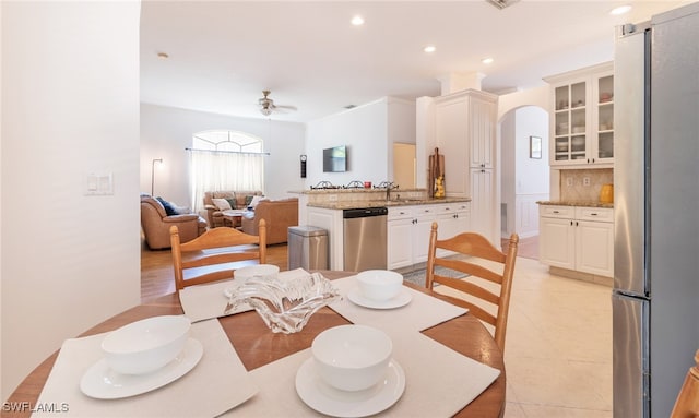 tiled dining area featuring sink and ceiling fan