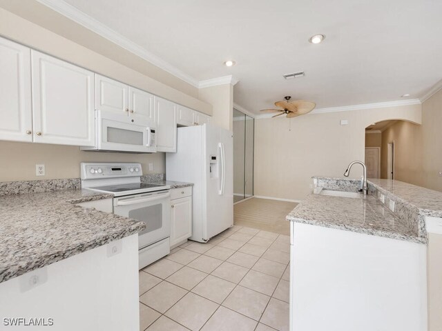 kitchen featuring white appliances, sink, ceiling fan, light tile patterned floors, and white cabinetry