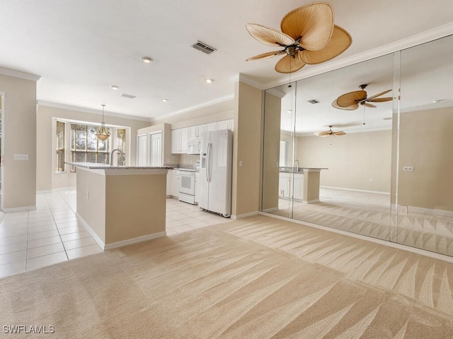 kitchen with white appliances, light colored carpet, crown molding, and light tile patterned floors