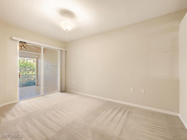 unfurnished room with light carpet, a ceiling fan, and baseboards