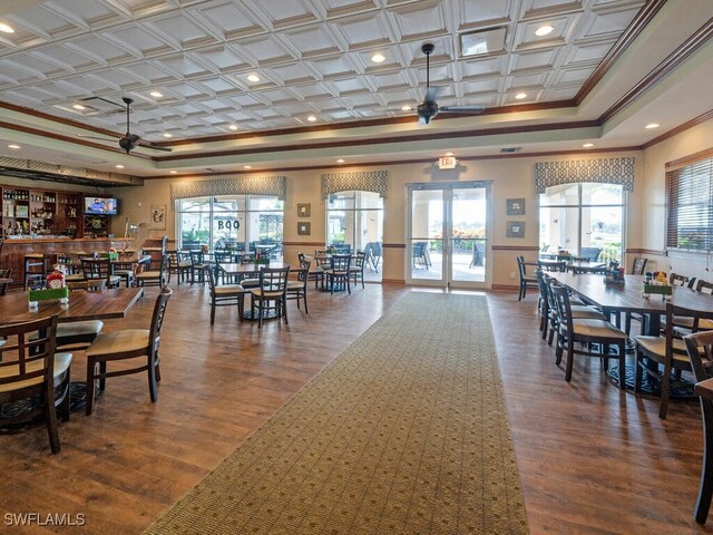 dining space featuring wood-type flooring, plenty of natural light, and ceiling fan