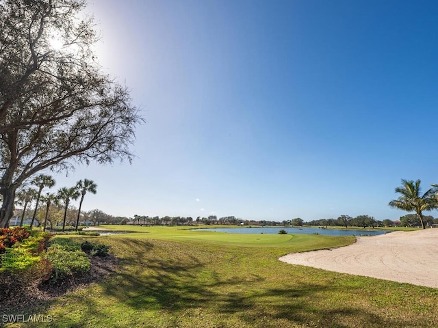 view of property's community featuring a water view and a lawn