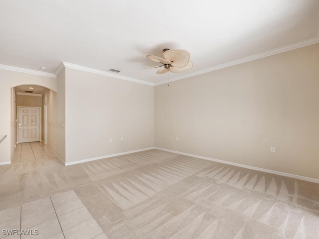 unfurnished room with arched walkways, visible vents, ornamental molding, a ceiling fan, and light carpet