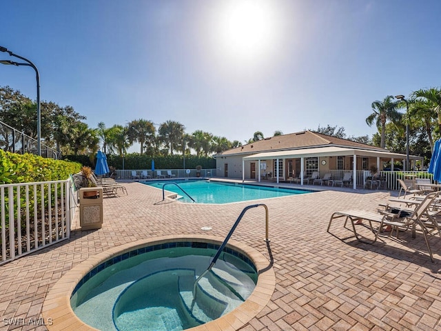 view of pool featuring a community hot tub and a patio