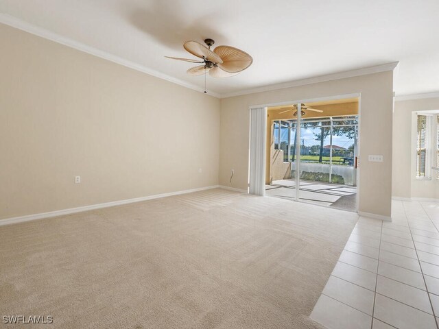 tiled empty room featuring plenty of natural light and crown molding