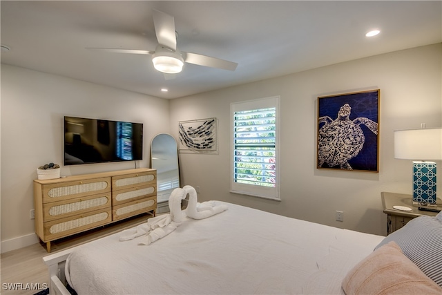 bedroom with ceiling fan and hardwood / wood-style floors