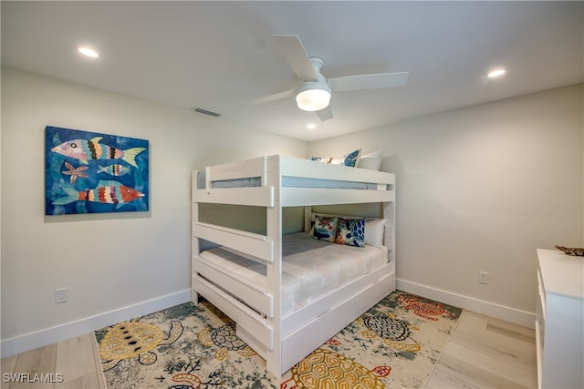 bedroom with ceiling fan and light hardwood / wood-style floors