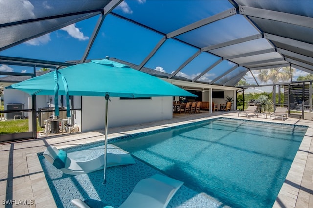 view of pool with a lanai and a patio area