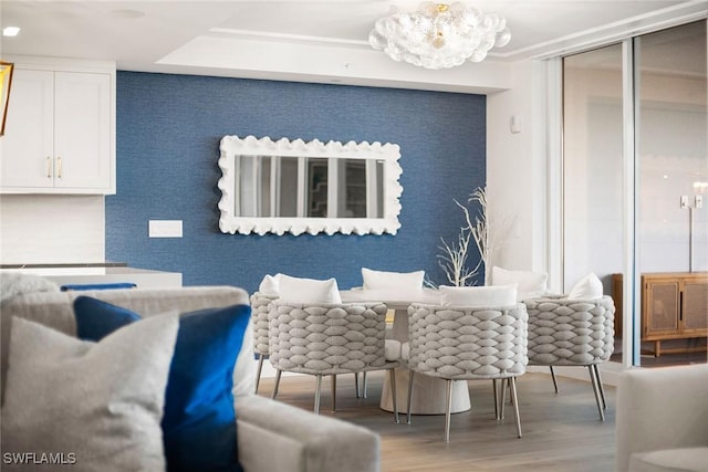 dining space with wood finished floors and a notable chandelier