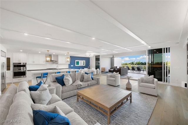 living area featuring light wood-style floors, recessed lighting, and expansive windows