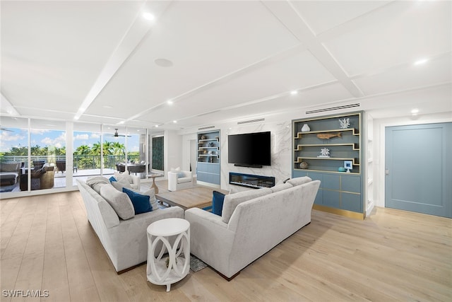 living room featuring expansive windows, light hardwood / wood-style flooring, a premium fireplace, and beam ceiling