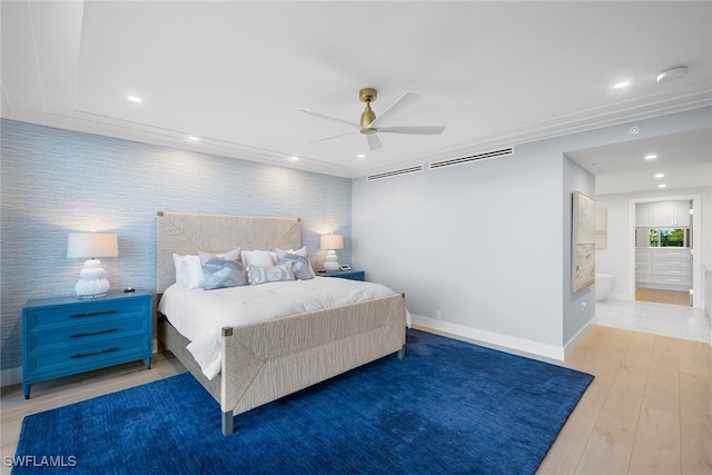 bedroom featuring ensuite bathroom, hardwood / wood-style flooring, and ceiling fan