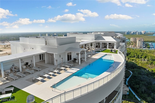 view of swimming pool featuring an outdoor bar and a patio area